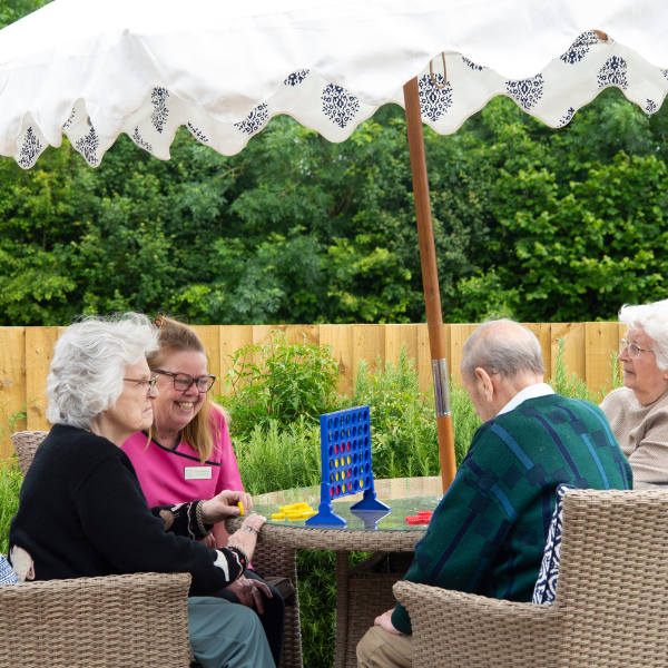 Happy elderly individuals enjoying companionship at Elliscombe House care home