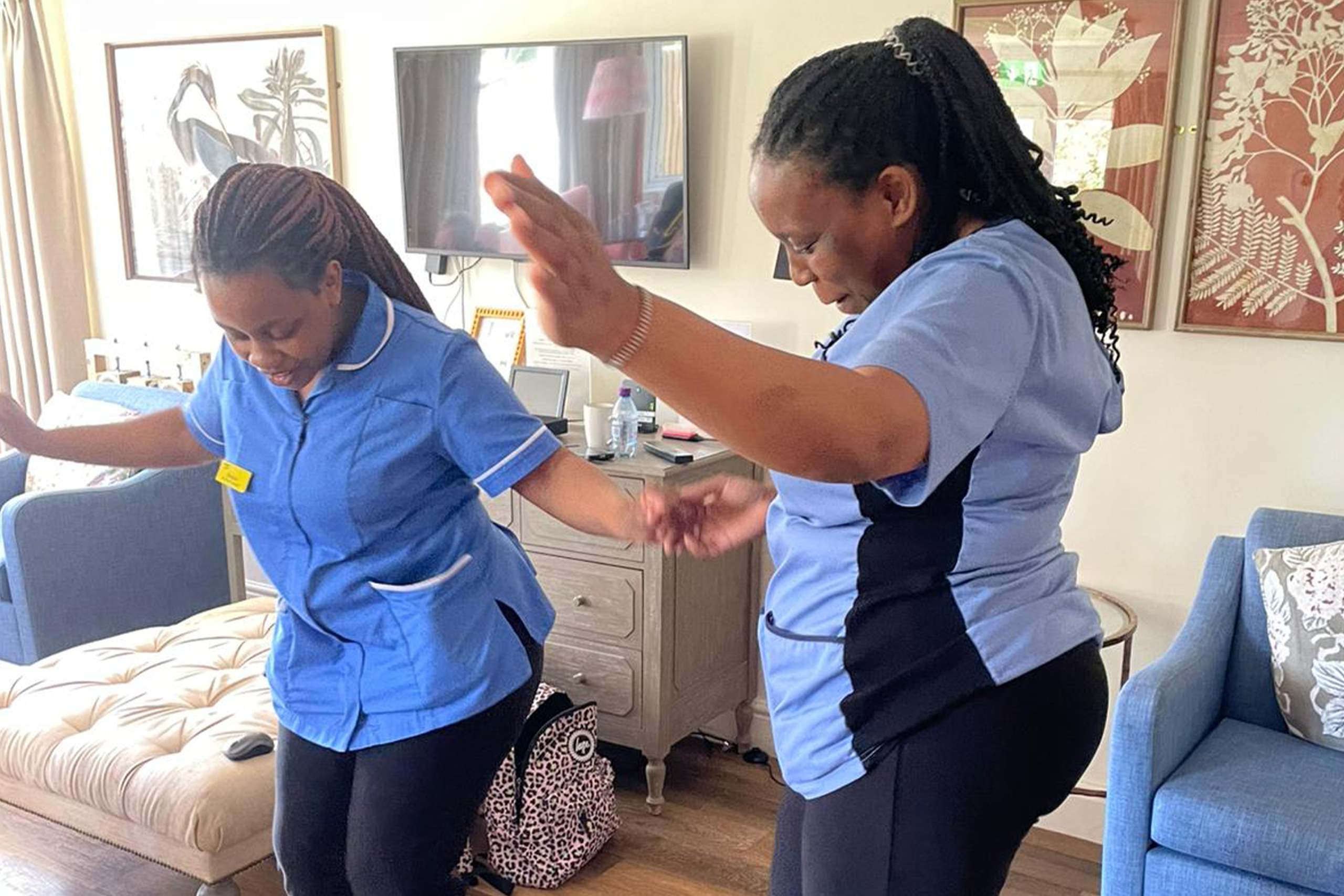 Happy elderly individuals enjoying companionship at Elliscombe House care home