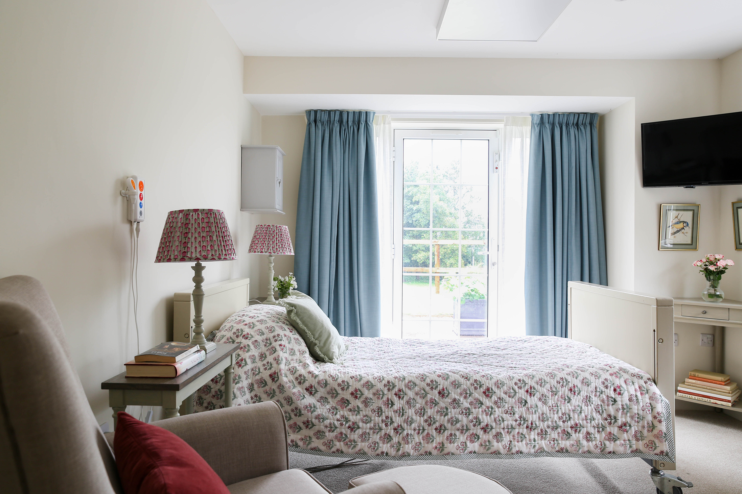 Comfortable bedroom designed for elderly residents at Elliscombe House in Somerset.